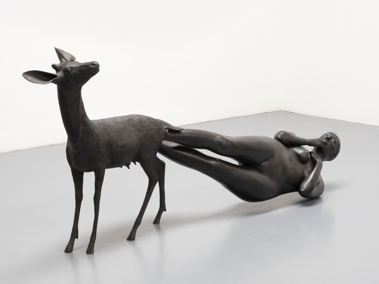 A statue of a person with a deer

Description automatically generated