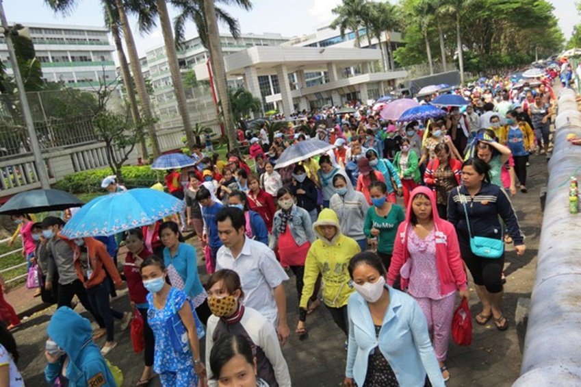 A group of people walking with umbrellas

Description automatically generated