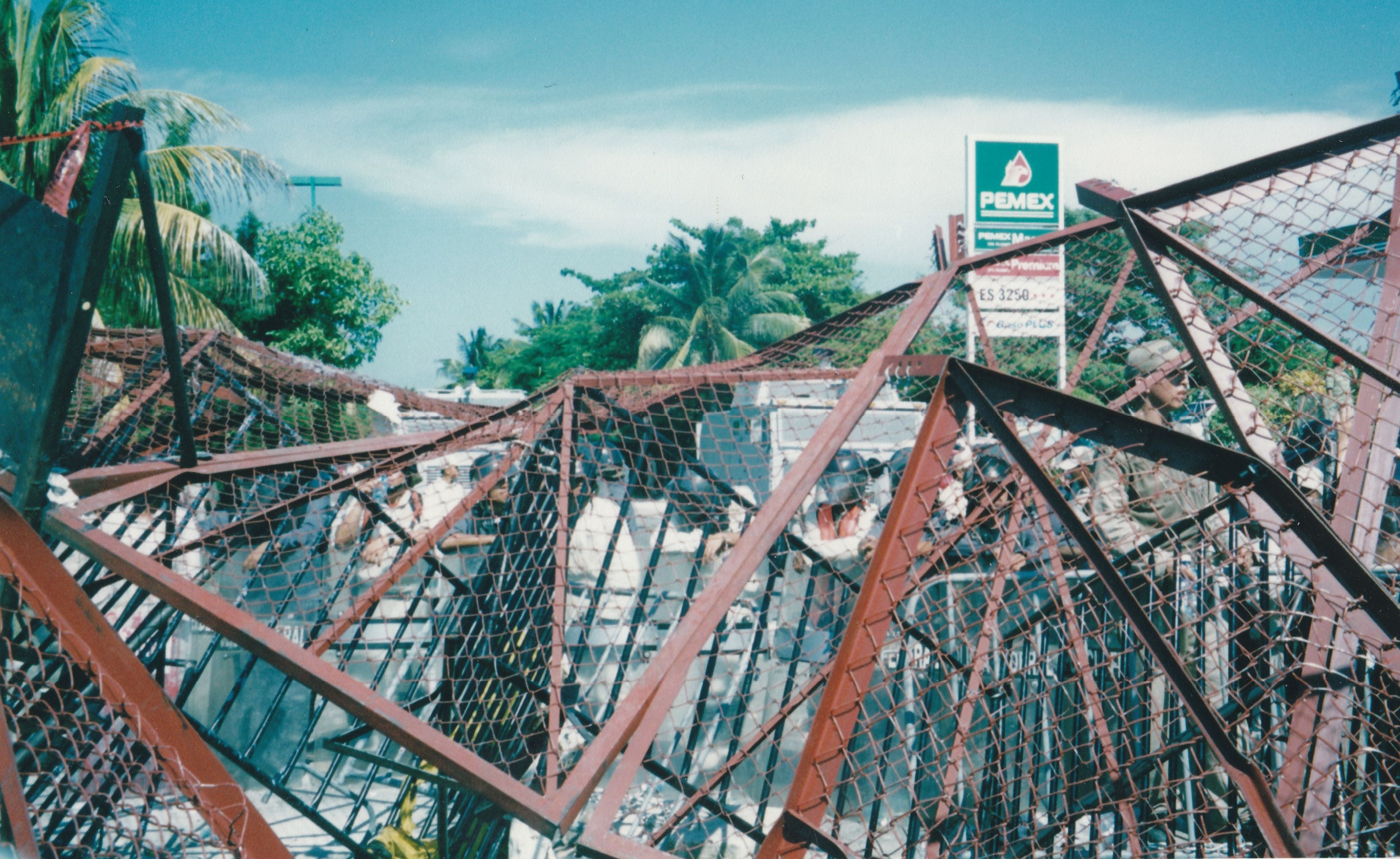 Chain-linked barricades piled the foreground and palm trees in the background.