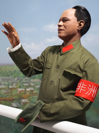 A person in a uniform with his hand raised

Description automatically generated