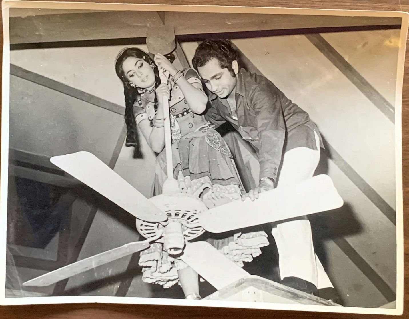 A person and person standing on a ceiling fan

AI-generated content may be incorrect.