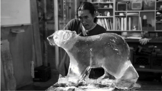 A person working on a ice sculpture

Description automatically generated