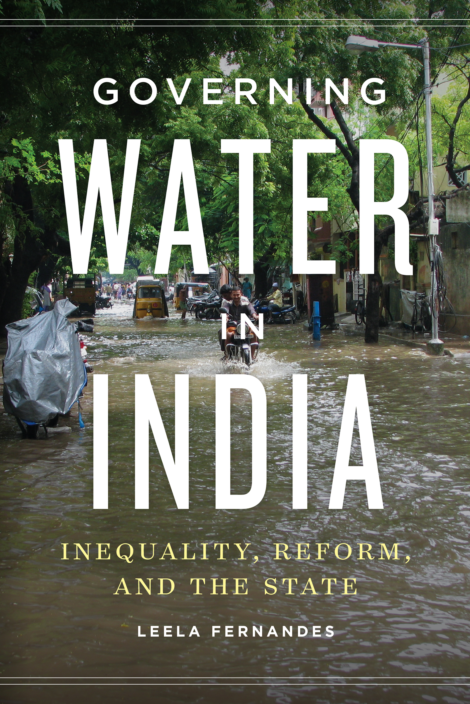The photo on the cover shows a flooded urban street under a canopy of lush green trees. Two men on a motorcycle and a few other small vehicles and pedestrians brave the water. The text reads, Governing Water in India, Inequality, Reform, and the State, Leela Fernandes.