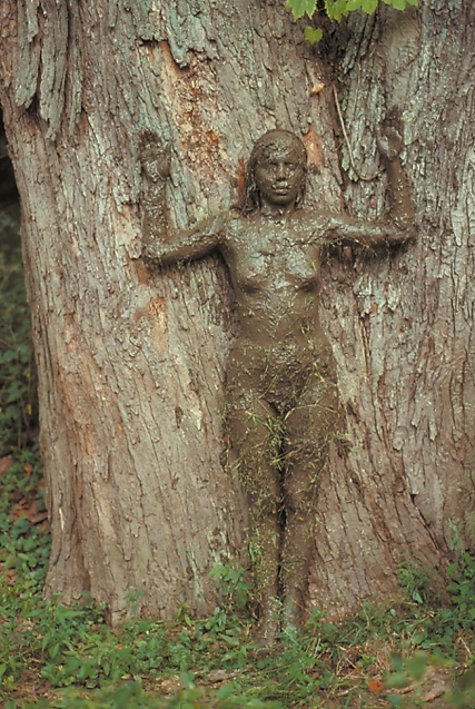 A person covered in mud

Description automatically generated