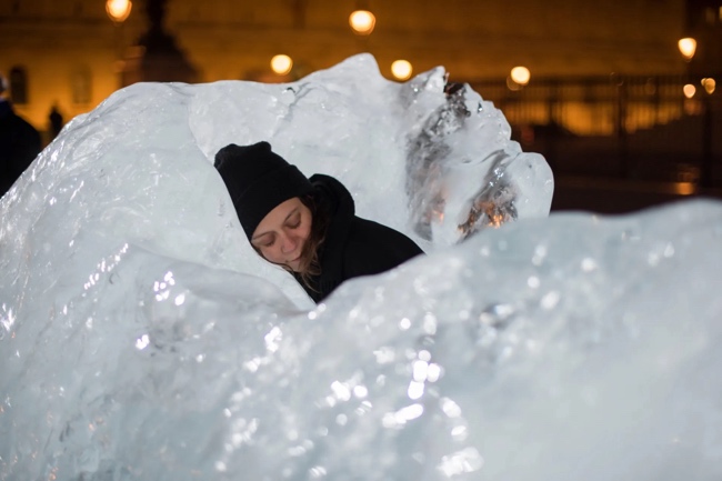 A person sleeping in a large ice sculpture

Description automatically generated