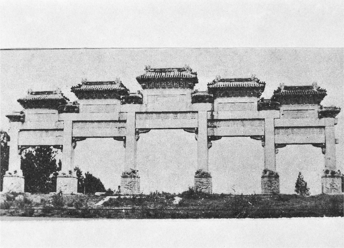 A photograph of a gate made of five large, square stone arches, each topped with a tiered roof.