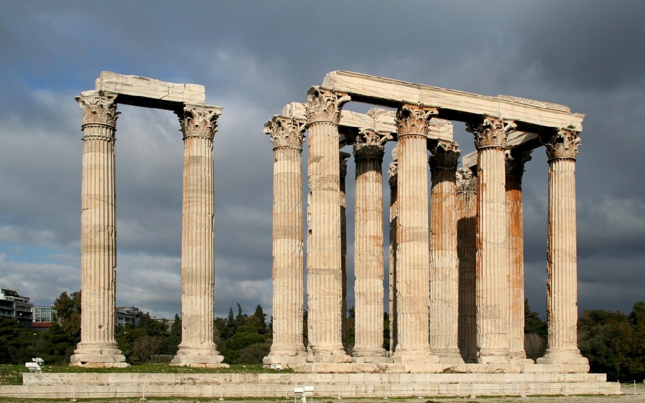 This image is a photograph of the remains of the Temple of Olympian Zeus at Athens, consisting of just a handful of Corinthian columns.
