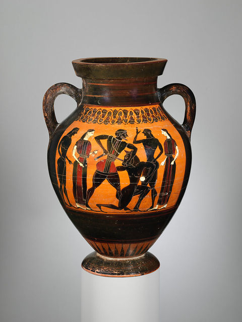 An ancient Greek amphora depicting the mythological scene of Theseus and the Minotaur. Theseus, stands over the Minotaur wielding a sword while the minotaur holds a white stone.