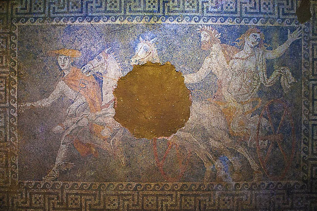 Hermes is on the far left leading the chariot aside, with Hades and Persephone astride a chariot pulled by two white horses. Hades holds onto persephone who is to the right of him in the chariot, and she is stretching a hand out to someone we do not see in the mosaic, likely her mother. 