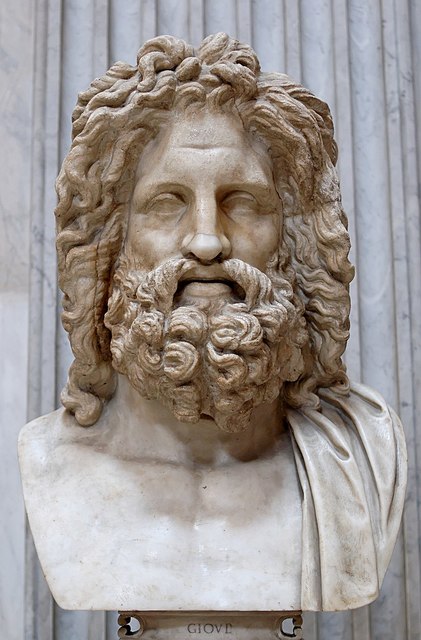 This is a cast of an over life-sized bust of Zeus discovered at Otricoli (Ocriculum), Italy in the 18th c. and housed in the Vatican. Zeus has a full, bushy head of curly hair and a full, bush, curly beard. His brow is furrowed, his nose is broad, and his lips are full.