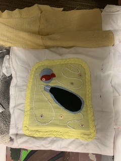 my quilt square: yellow basket with a blue dynamite bottle and a red fish encapsulated by a blue bubble. 