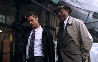In this image we see Detective David Mills on the left (played by Brad Pitt) and Detective William Somerset on the right (played by Morgan Freeman). This image shows the two detectives walking away from a crime scene where Somerset tries to make sense of the murder. 