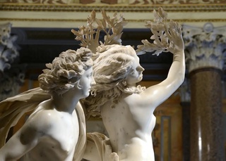 The statue depicts Apollo and Daphne in a near-close embrace. Half of Daphne is slowly getting turned into a laurel tree just as Apollo is trying to touch her. The sculpture is made of white marble. This sculpture looks like Apollo and Daphne are in an intimate embrace, but Daphne is escaping from Apollo's advances.